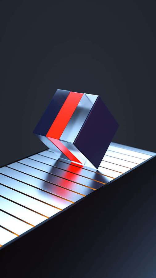 A colorful cube balanced on a glowing metal surface in a dark studio setting. — Bounce Picture