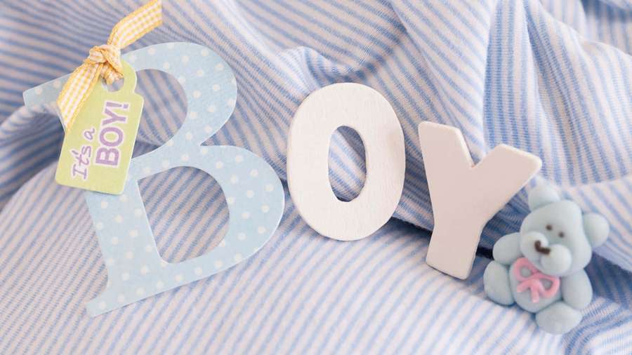 Wooden letters spelling BOY with a teddy bear and tag on striped fabric — Boy Background