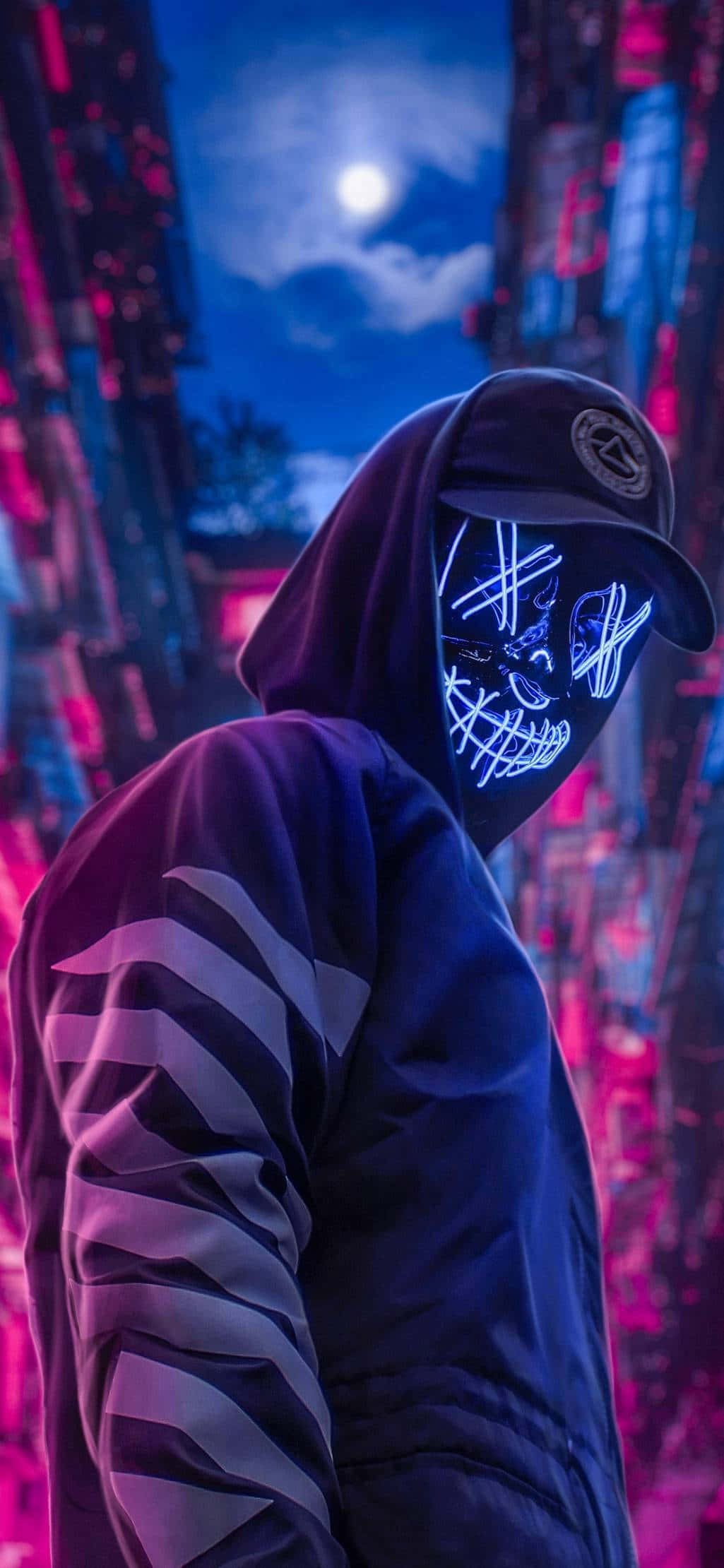 Person in hoodie with glowing skull mask in neon-lit city at night. — Boy Phone Wallpaper