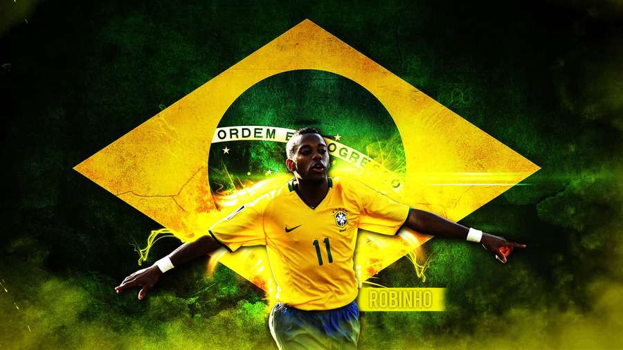 Footballer Robinho in Brazil jersey celebrating with arms outstretched against glowing flag. — Brazil Background