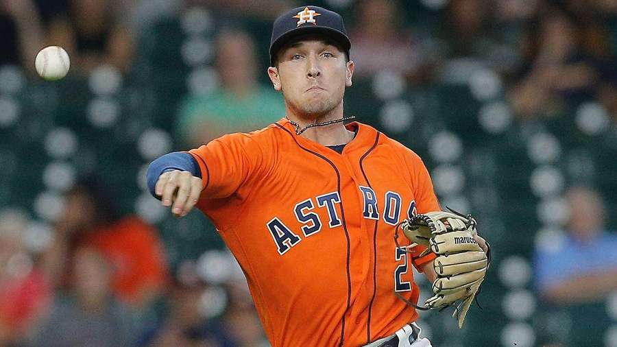 Baseball pitcher throwing a pitch in a stadium at night. — Bregman Wallpaper