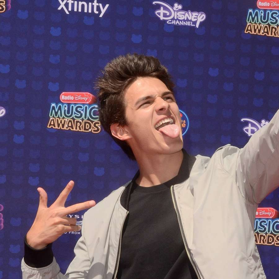 Young man posing with tongue out at music awards — Brent Rivera Background