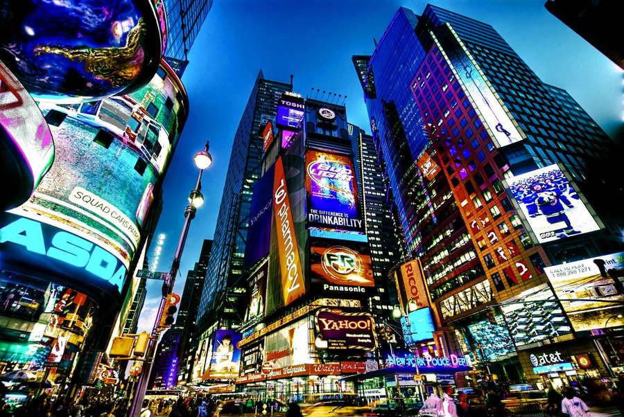 Times Square at night with glowing billboards and tall buildings. — Broadway Wallpaper