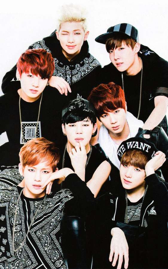 Seven stylish young men in black outfits with colorful hair posing in a studio. — Bts Phone Wallpaper