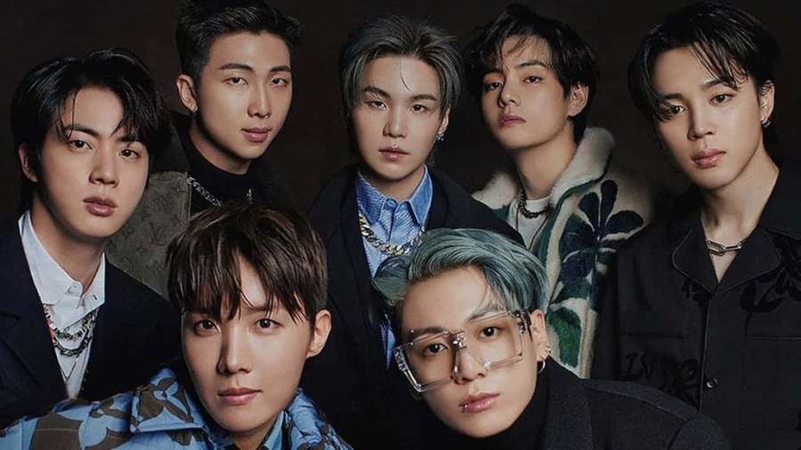 Seven K-pop idols in stylish outfits posing for a studio portrait. — Bts Picture