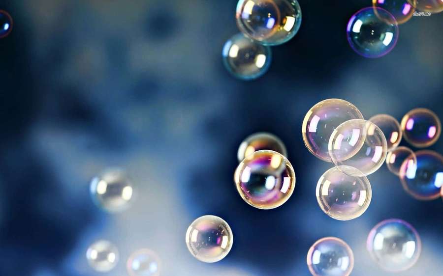 Floating iridescent soap bubbles reflecting light against a soft blue background. — Bubbles Picture