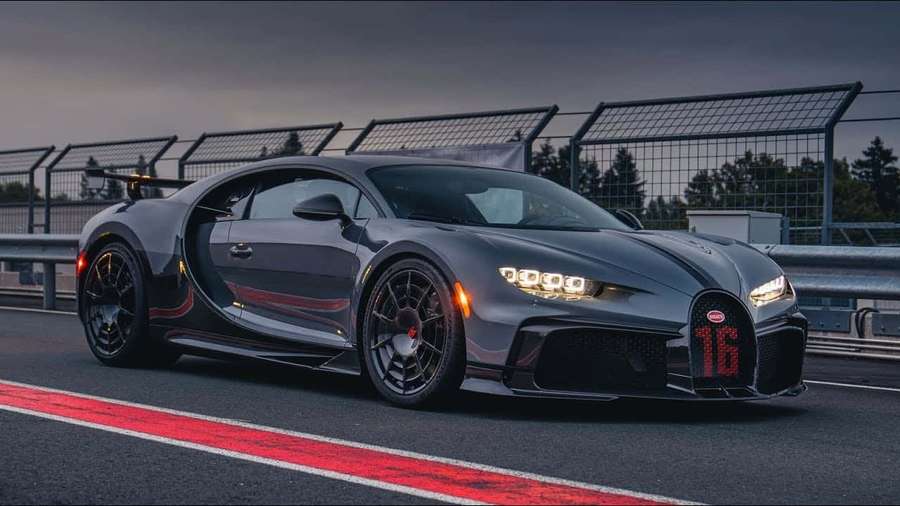 Matte gray Bugatti Chiron on racetrack with red number 16 glowing at dusk. — Bugatti Picture