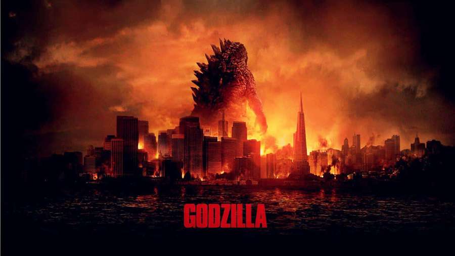 Godzilla emerges from water to destroy a burning city at night. — Burning Godzilla Wallpaper