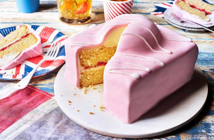 Pink car-shaped cake with white drizzle on a plate with Union Jack plate and iced tea. — Cake Fondant Wallpaper
