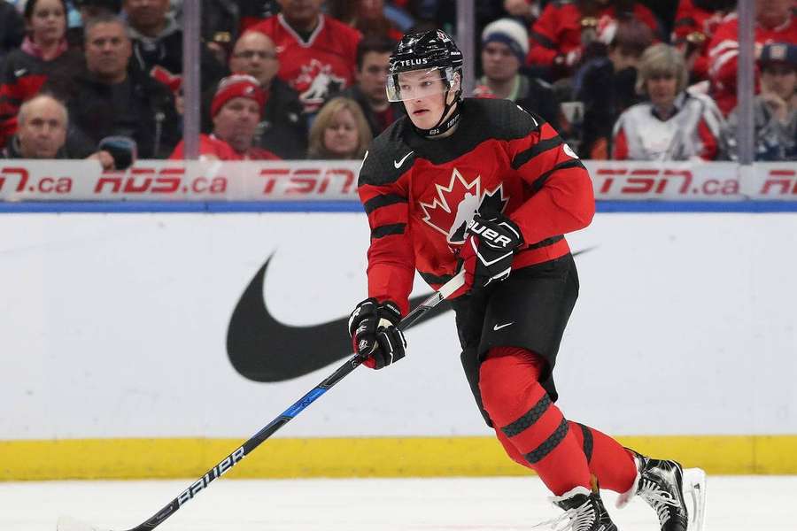 Canadian hockey player skating during game with crowd behind glass. — Cale makar Wallpaper