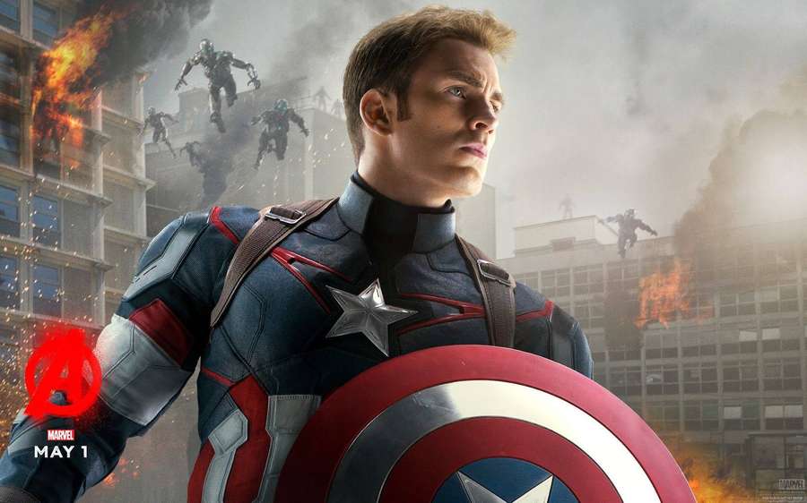 Capitão América segurando escudo em meio a cidade em chamas com inimigos robóticos atacando — Captain America Papéis de Parede