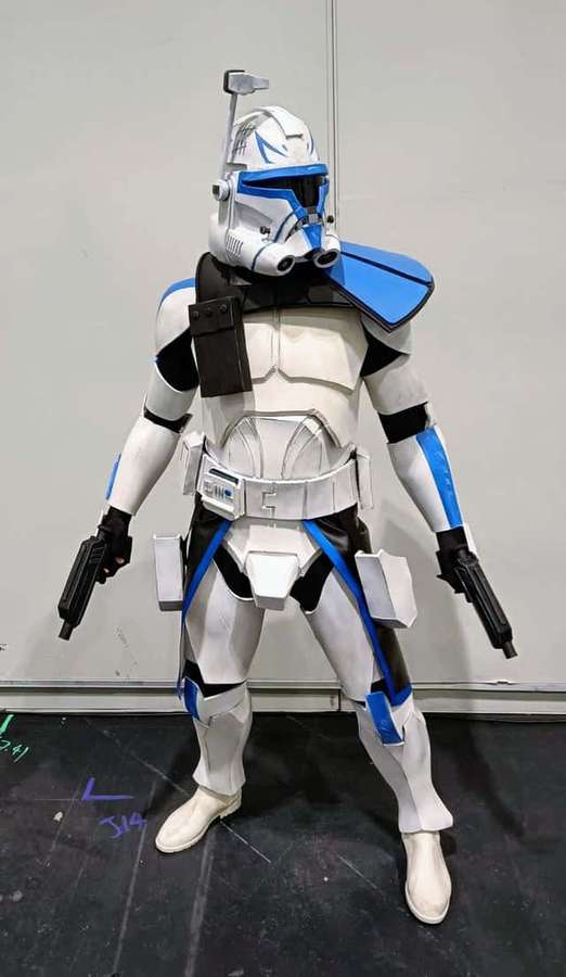 A person in a detailed clone trooper costume holding two blasters. — Captain Rex Wallpaper