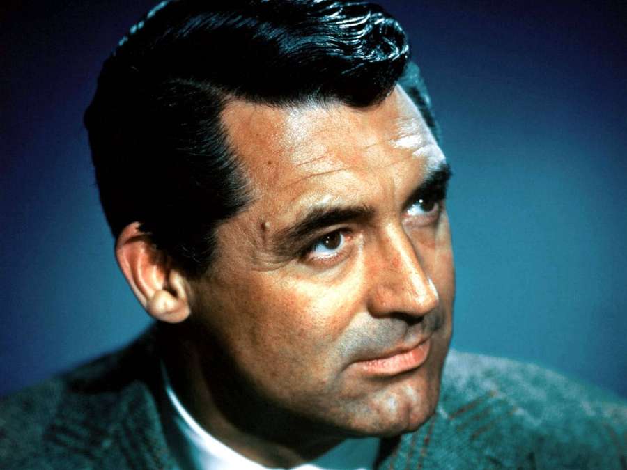 Close-up portrait of a man with dark hair and serious expression. — Cary grant Wallpaper