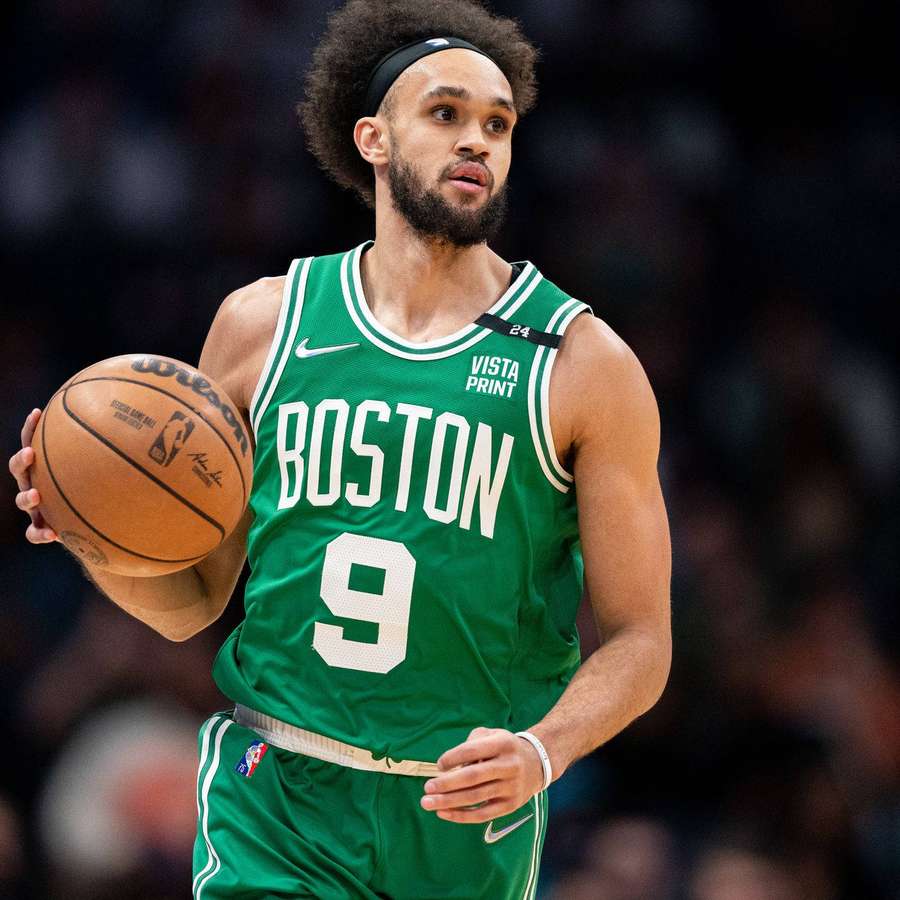 Boston Celtics player holding basketball during game — Celtics Background