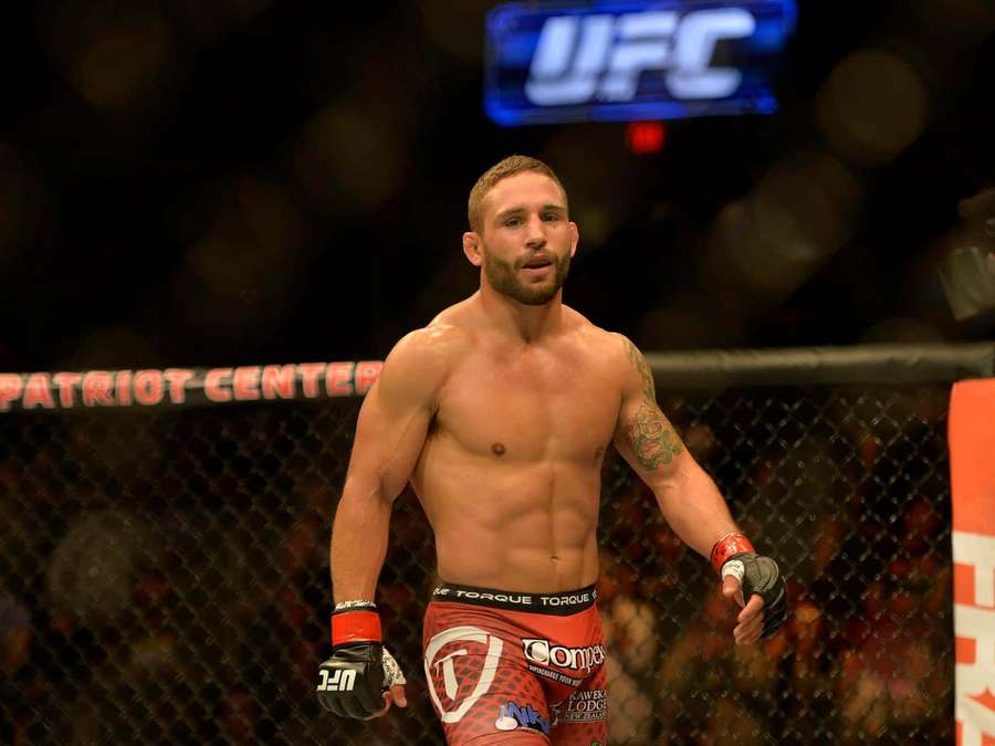 UFC fighter in red shorts standing inside the octagon at Patriot Center. — Chad Mendes Wallpaper