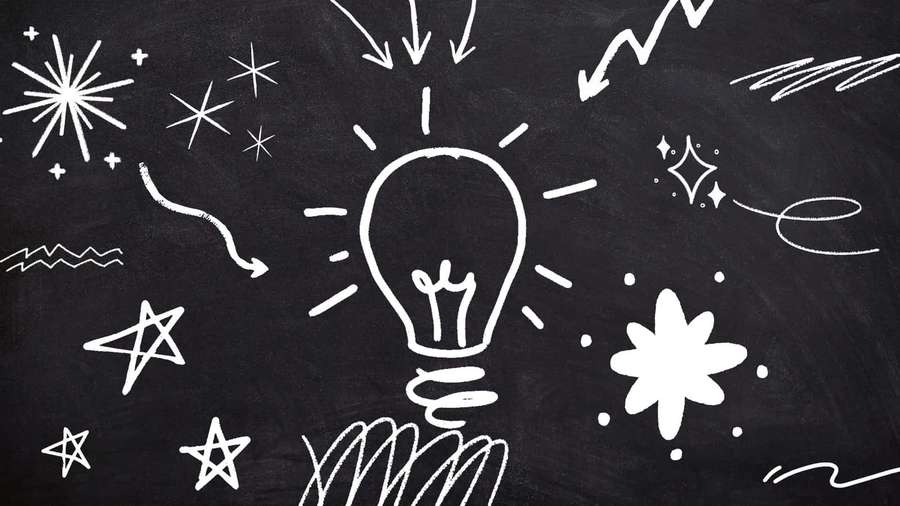 Chalk drawing of a glowing lightbulb surrounded by stars and arrows on a blackboard. — Chalkboard Background
