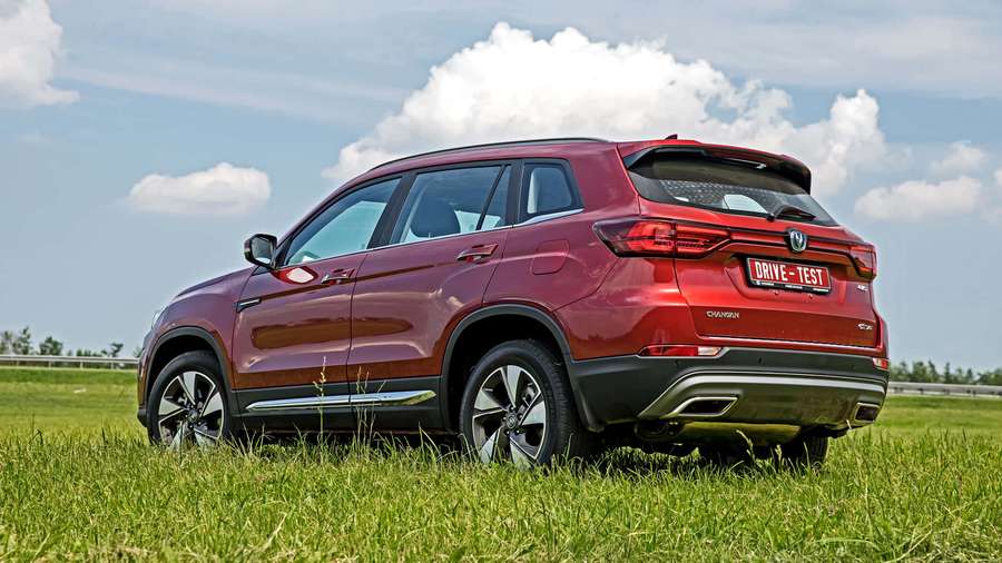 Red SUV parked on grass under a blue sky with clouds. — Changan Cs75 Wallpaper