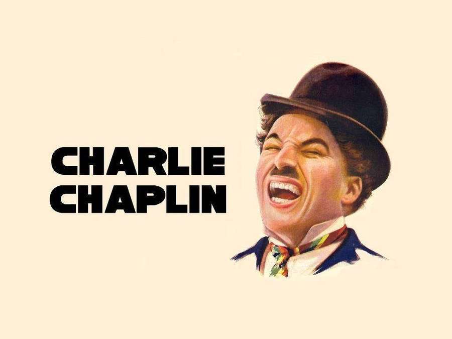 Charlie Chaplin laughing with his signature bowler hat and mustache. — Chaplin Background