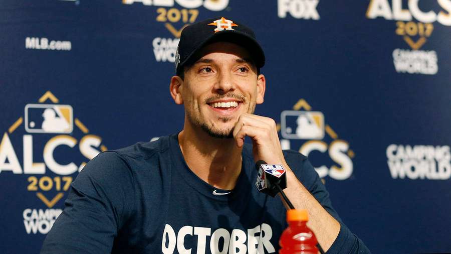 Baseball player smiling at press conference wearing Astros cap and October shirt. — Charlie Morton Wallpaper