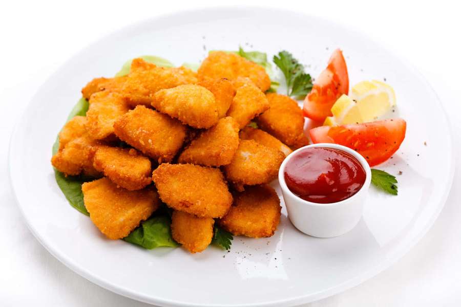Crispy chicken nuggets with tomato lemon and ketchup on a white plate. — Chicken Nuggets Wallpaper