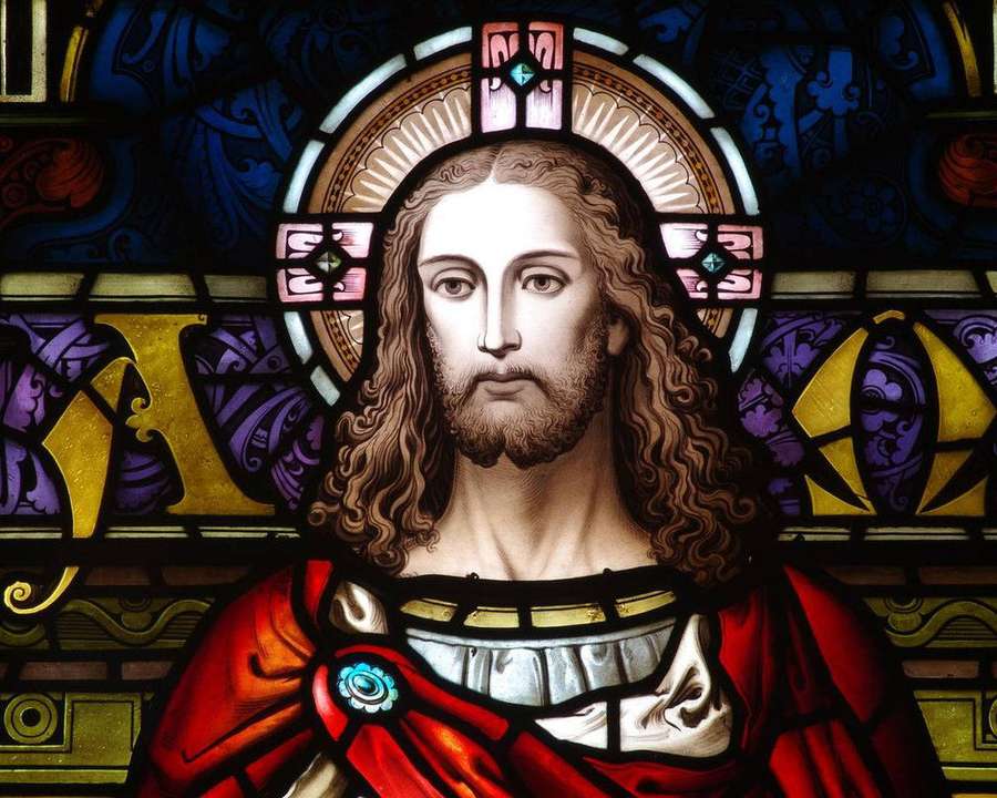 Stained glass window showing Jesus Christ with halo and red robe. — Christianity Background