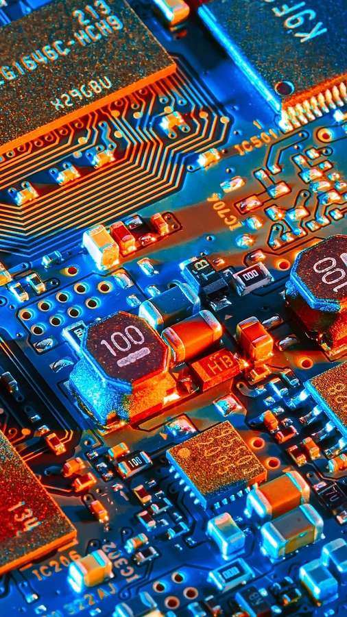 Close-up of a colorful circuit board with glowing components and text labels. — Circuit iPhone Wallpaper