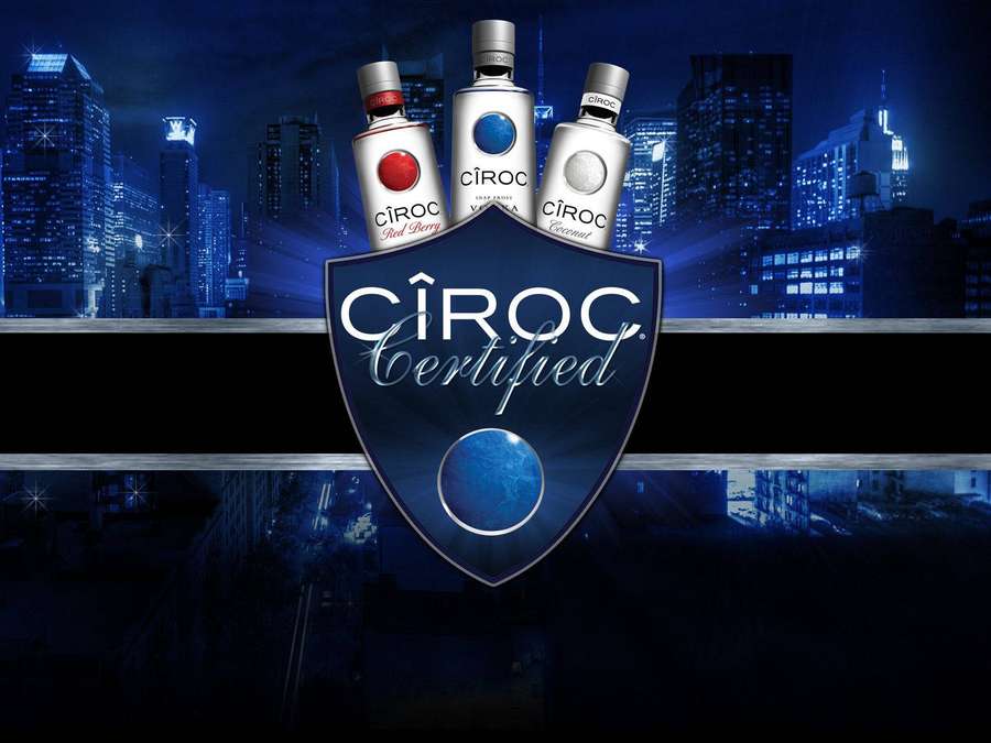 Cîroc vodka bottles displayed with shield logo over nighttime cityscape. — Ciroc Picture