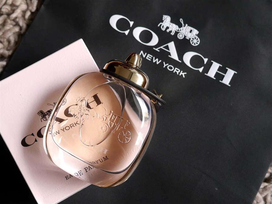Coach perfume bottle with packaging on textured surface — Coach Picture