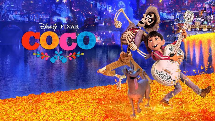 Boy and skeleton dancing with dog on marigold petals in vibrant cityscape. — Coco Background