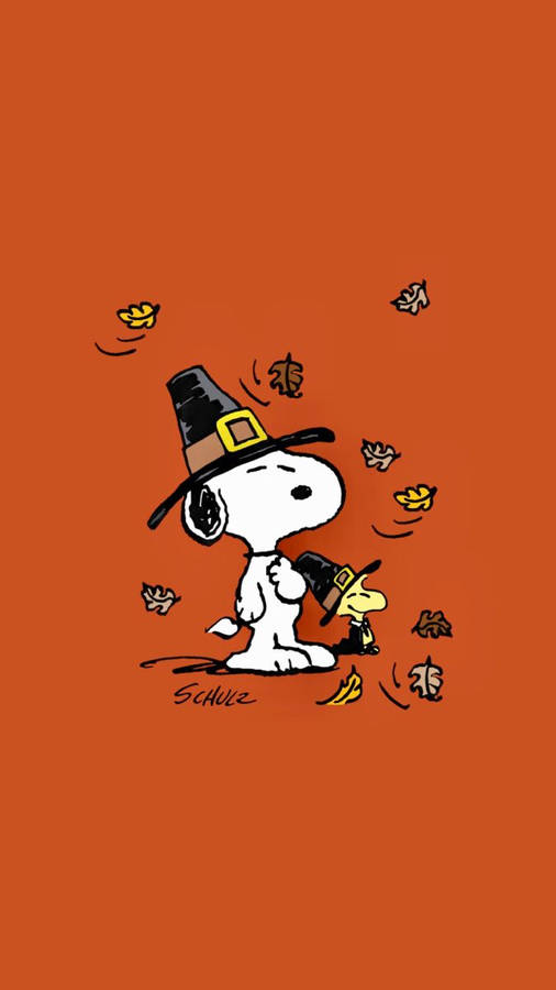 Snoopy och Woodstock i pilgrimsmössor med fallande löv på orange bakgrund — Serie-tidningar Bakgrundsbilder
