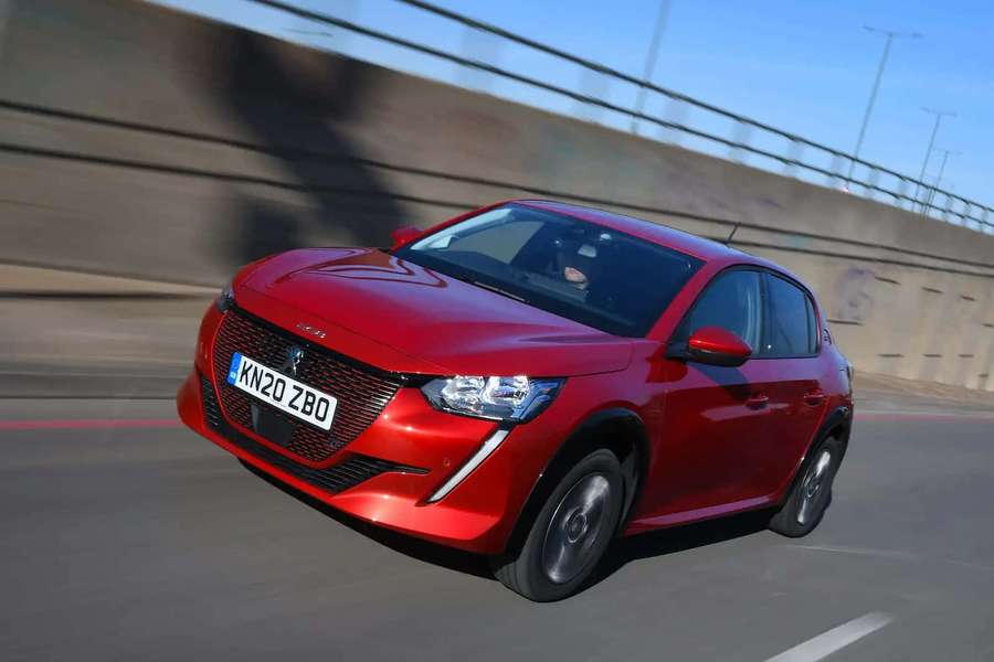 Red Peugeot 208 speeding on highway with motion blur — Compact Car Wallpaper