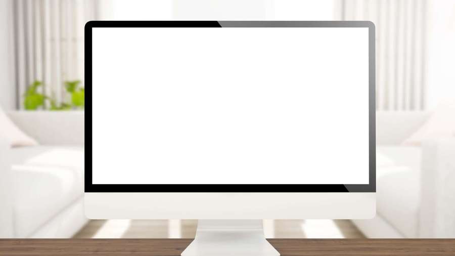 White computer monitor on wooden desk in bright modern living room. — Computer Screen Background