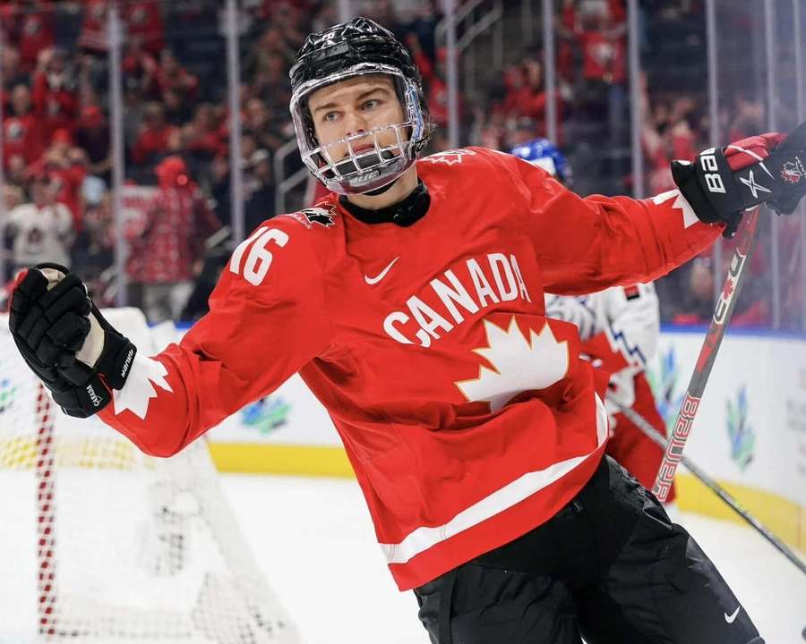 Canadian hockey player celebrating a goal during a game. — Connor Bedard Wallpaper