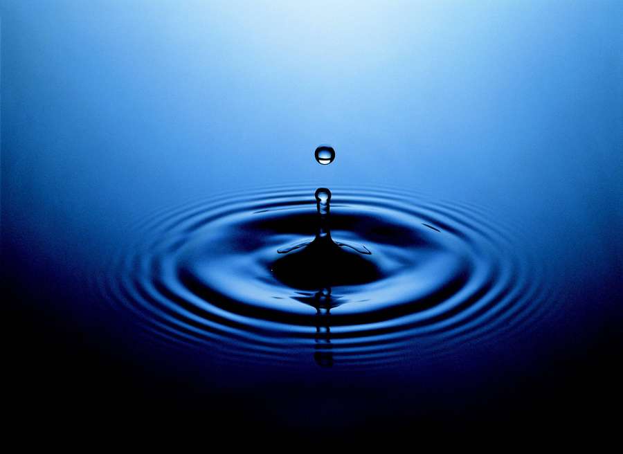 A droplet hovers above water ripples in deep blue light. — Cool 3d Water Wallpaper