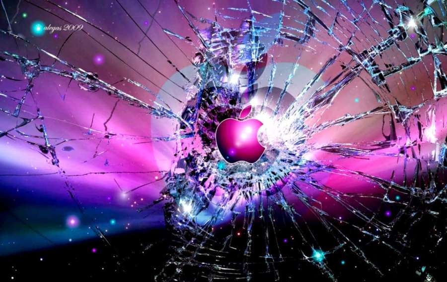 A glowing Apple logo breaking through shattered glass against a starry cosmic background. — Cool Computer Wallpaper