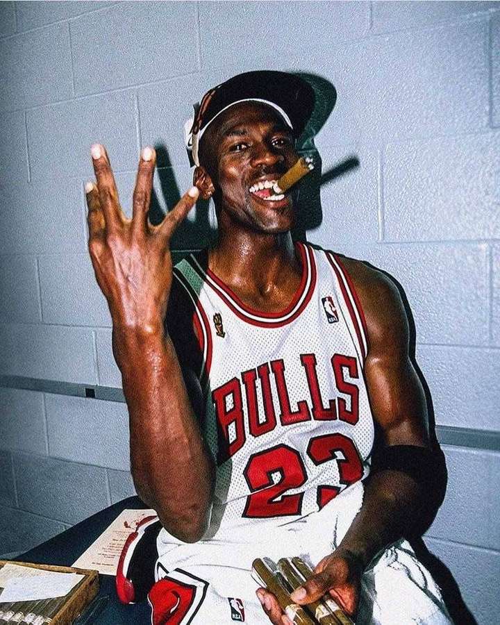 Michael Jordan im Bulls-Trikot hält eine Zigarre und zeigt vier Finger. — Cooles Jordanien Wallpaper