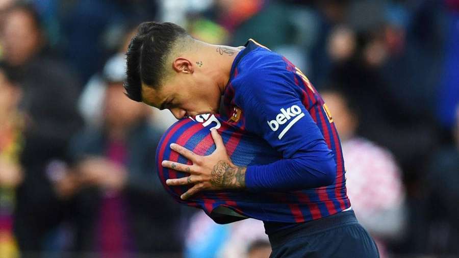 Football player hugging a ball with eyes closed in stadium — Coutinho Wallpaper