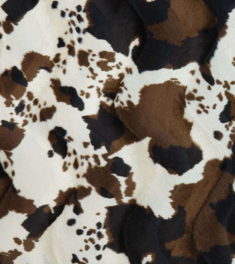 Soft plush blanket with cow print pattern in brown black and white. — Cowhide Background