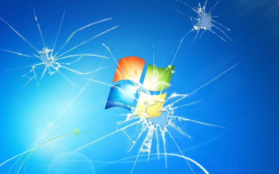 Shattered glass effect with Windows logo centered on blue background. — Cracked Computer Screen Background