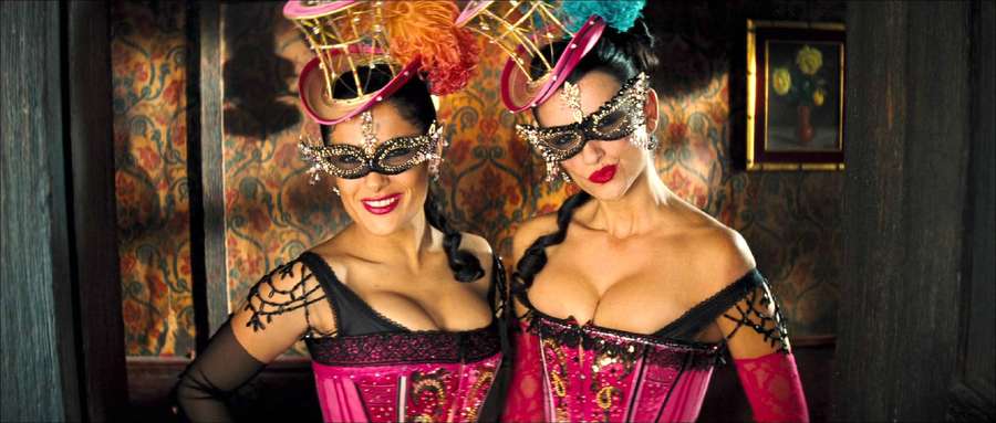 Two masked women in elaborate pink and black costumes posing indoors. — Cruz Wallpaper