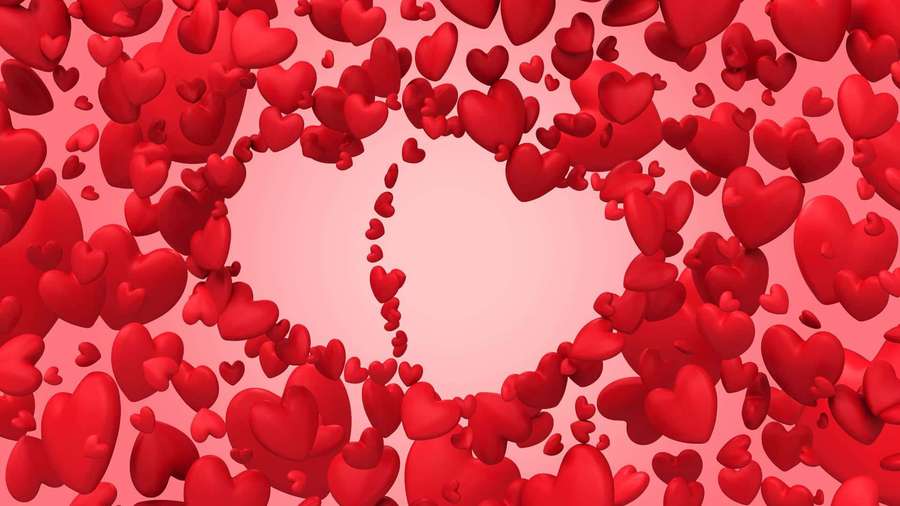 Floating red hearts form a heart-shaped frame against a pink background. — Cute Heart Background