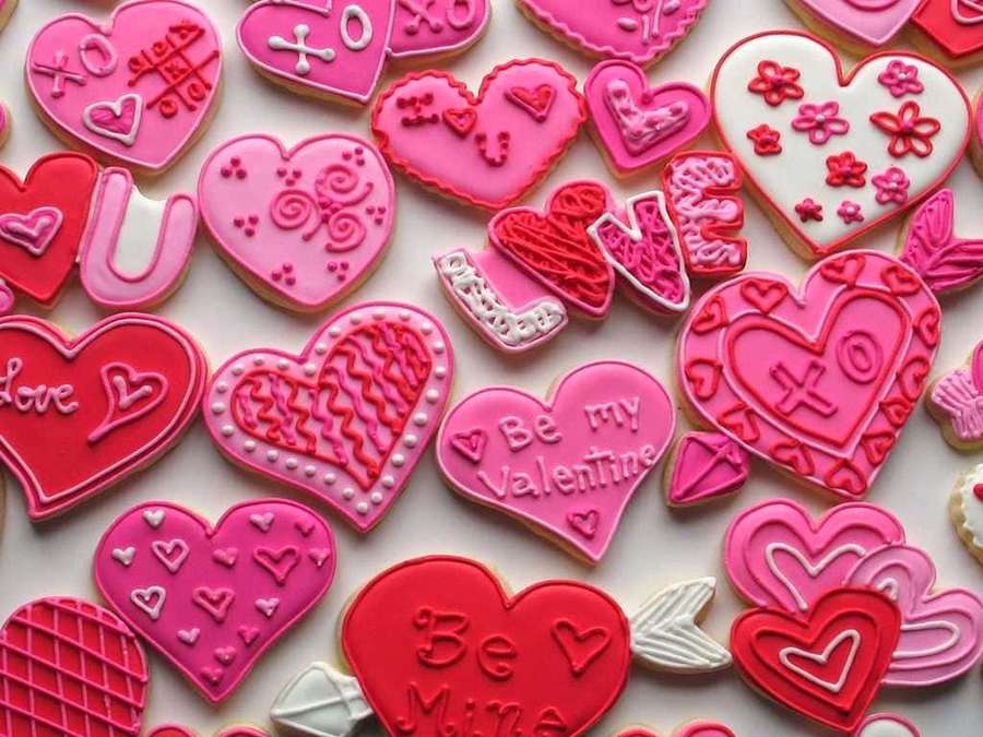 Heart-shaped cookies with Valentine's Day messages and decorations in pink and red. — Cute Valentines Wallpaper