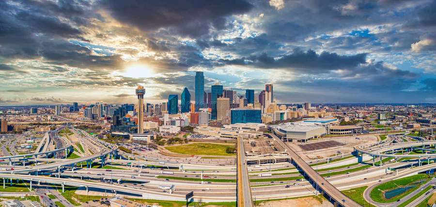 Houston cityscape at sunset with highways and skyscrapers under dramatic clouds. — Dallas Texas Wallpaper