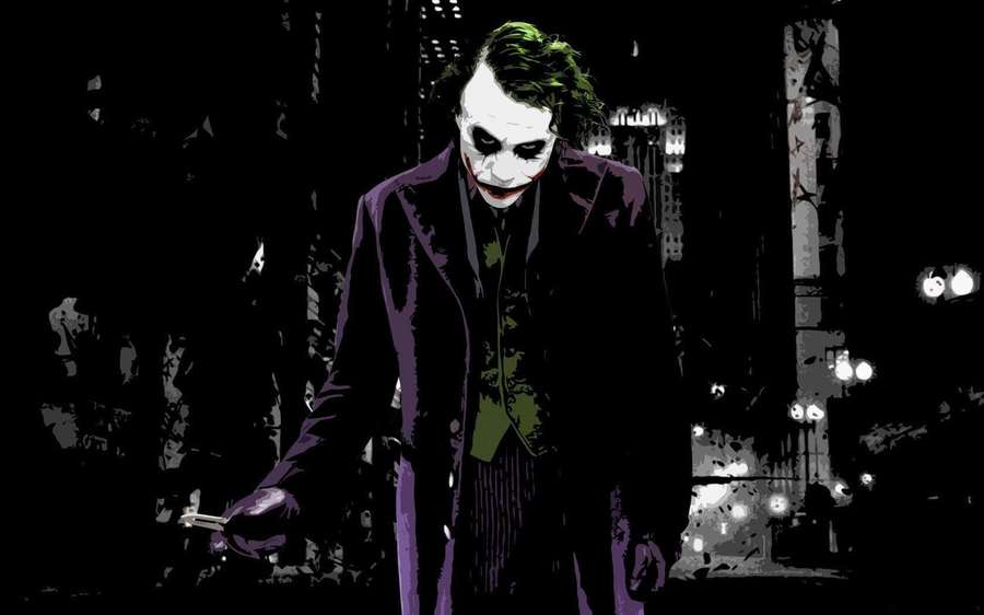 The Joker in a purple suit stands in a dark city at night. — Dangerous Joker Wallpaper