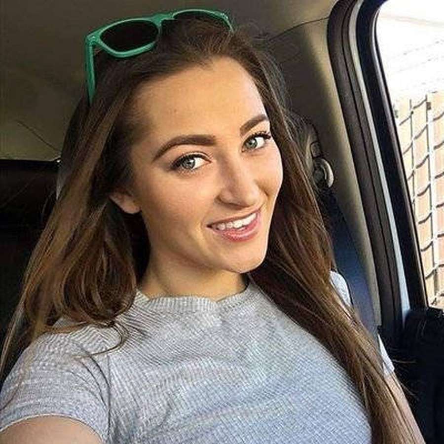 Young woman smiling in a car with green sunglasses on her head. — Dani Daniels Background