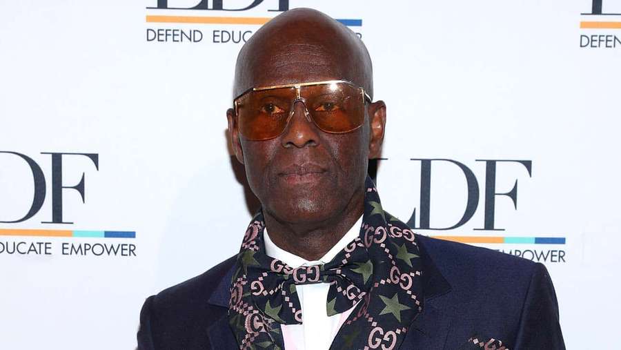 Man in sunglasses and patterned scarf at a formal event. — Dapper Wallpaper