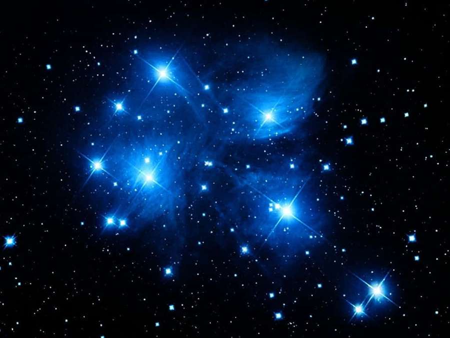 A vibrant blue star cluster glowing in the dark night sky. — Dark Blue Star Wallpaper