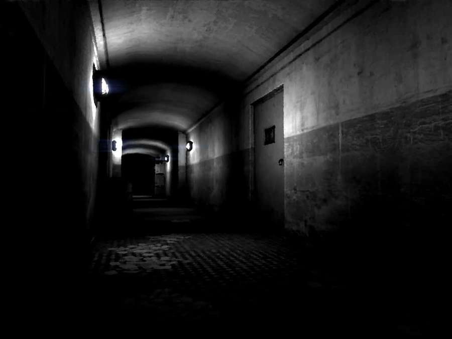 Long dark concrete tunnel with flickering lights and checkered floor. — Dark Corner Wallpaper