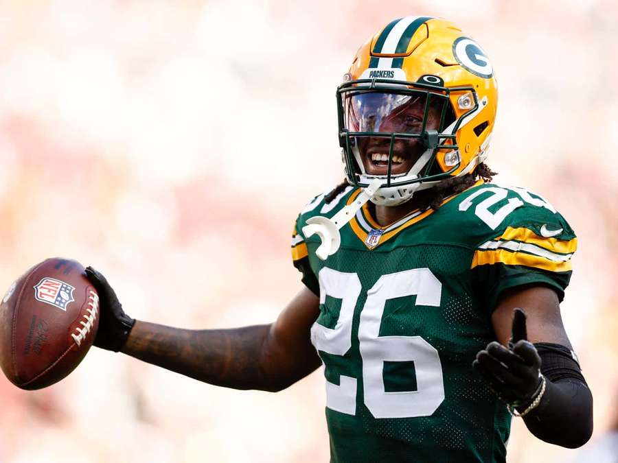 Green Bay Packers football player celebrating with a football and thumbs up. — Darnell Savage Wallpaper