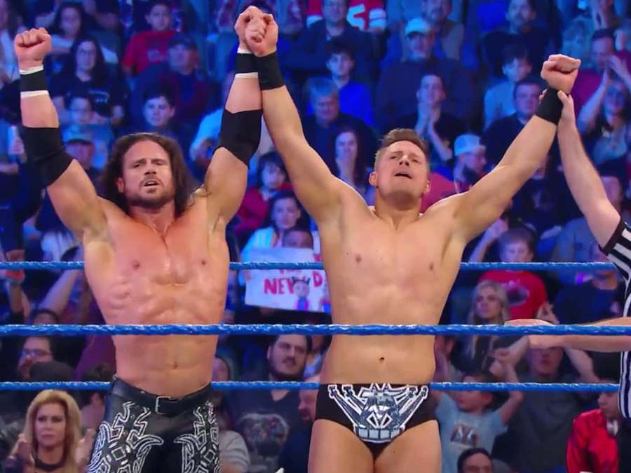 Zwei Wrestler heben die Fäuste im Sieg in einem Wrestling-Ring mit jubelnden Fans. — Das Miz Wallpaper